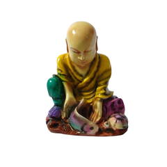 Shaolin sitting with a fish and turtle yellow in resin  12 cm high