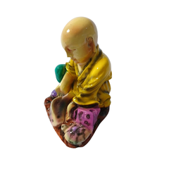 Shaolin sitting with a fish and turtle yellow in resin  12 cm high